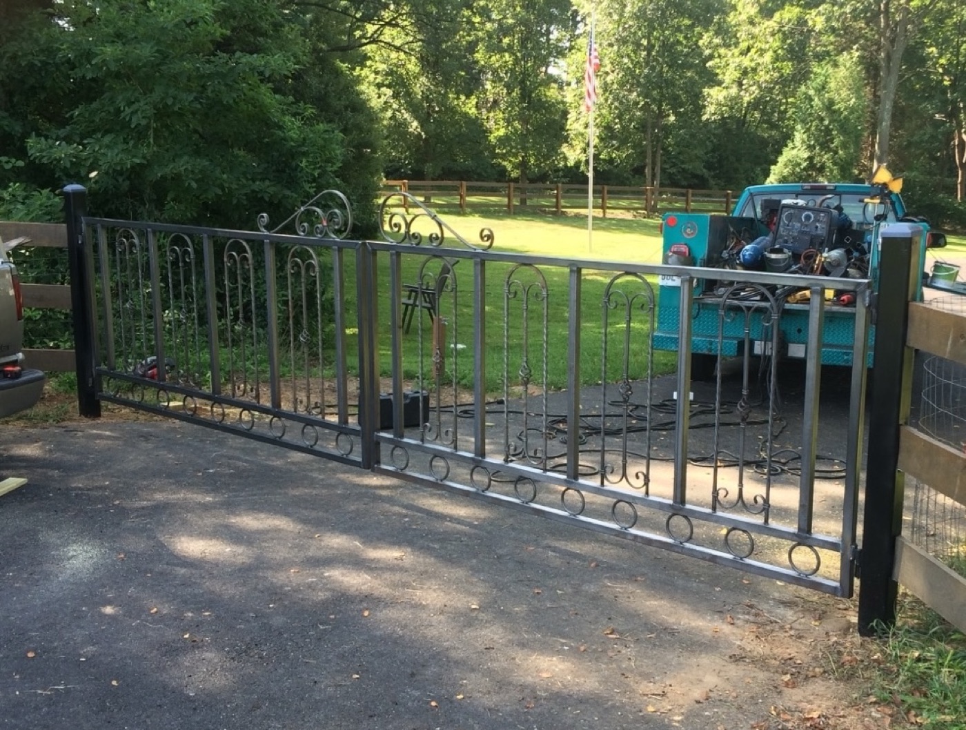 Custom welded iron driveway gate built by Stewart's, mobile welding truck behind