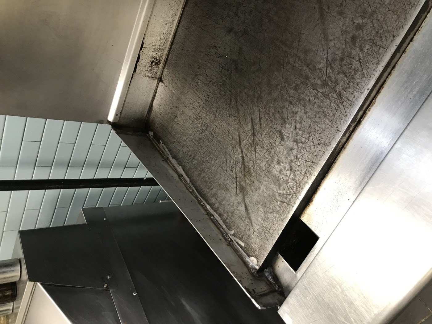 Stainless reach-in cooler facing and trim in a cafeteria