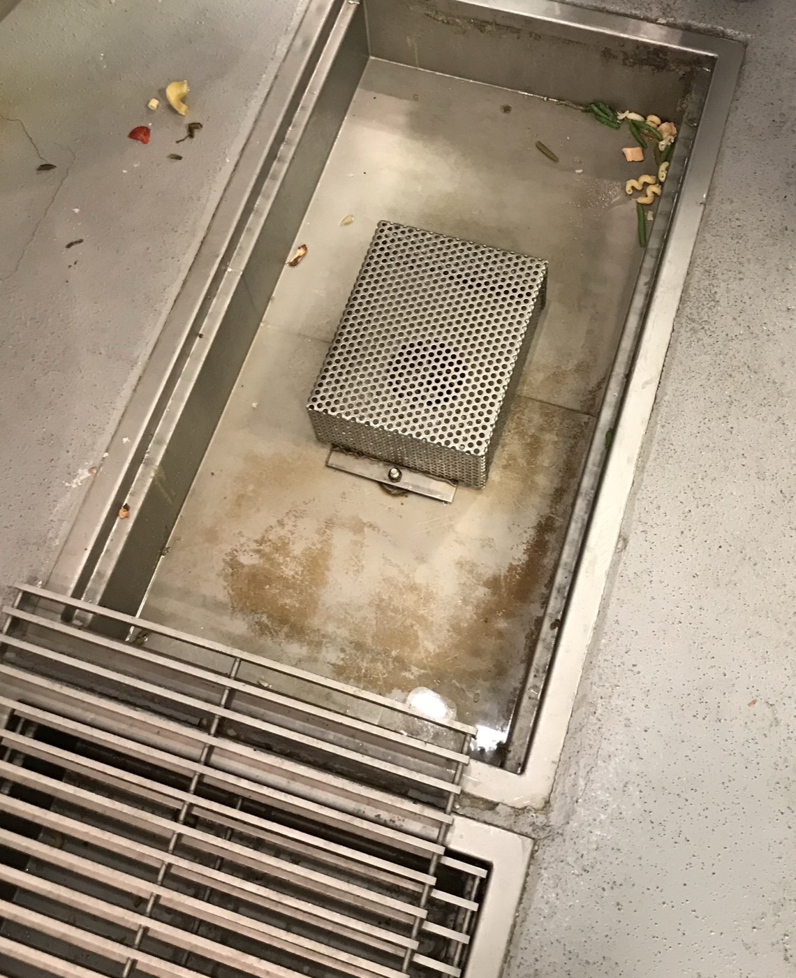 Stainless floor drain and strainer basket in a commercial kitchen